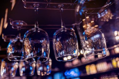 Restorandaki barın üstündeki rafta şarap ve martini bardakları var..