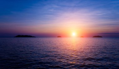 Tropiklerdeki sahilde güzel bir gün batımı. Gökyüzü ve okyanus