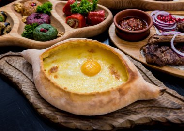Peynirli, sebzeli ve yumurtalı Khachapuri. Gürcistan ulusal mutfağı.