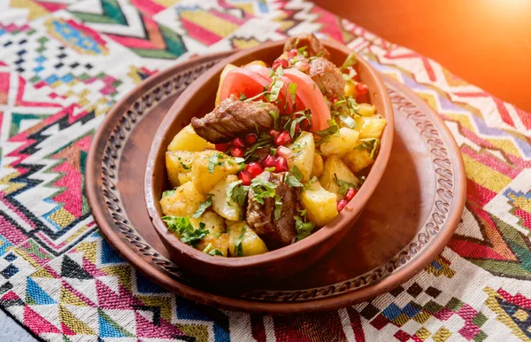 Pommes de terre frites avec des morceaux de viande dans une casserole en argile. Cuisine européenne . — Photo