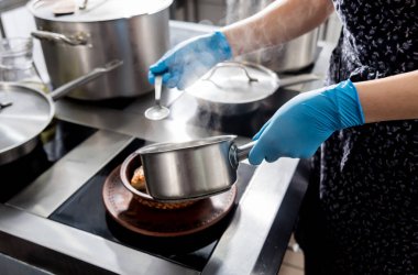 Roasted chicken with potato and vegetables on kitchen stove. 