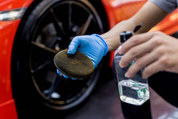 Trabajador de servicio de coche puliendo ruedas de coche con tela de microfibra. —  Fotos de Stock