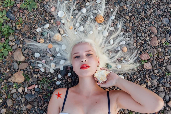 Jovem mulher com conchas no cabelo . — Fotografia de Stock