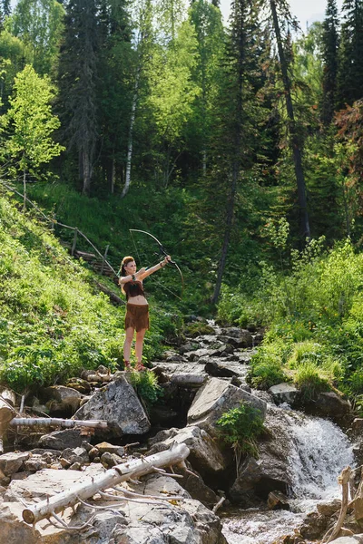 Young beautiful amazon girl hunting in the forest — Stock Photo, Image