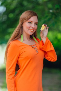 Sulu lezzetli turuncu yaz yeşil park ile oldukça Kızıl saçlı kadın portresi.