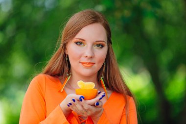 Sulu lezzetli turuncu yaz yeşil park ile oldukça Kızıl saçlı kadın portresi.