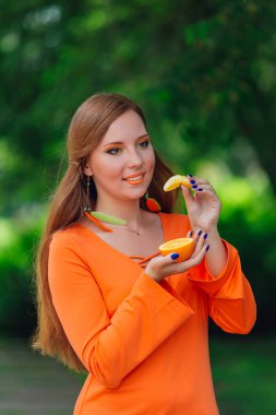 Sulu lezzetli turuncu yaz yeşil park ile oldukça Kızıl saçlı kadın portresi.