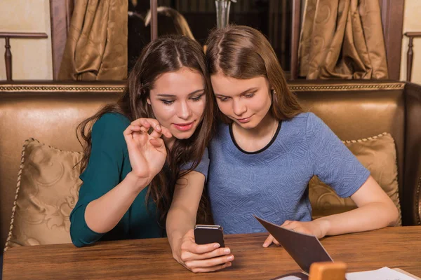 Two beautiful women taking selfie in cafe — Stock Photo, Image