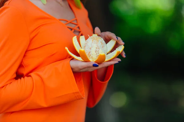 Retrato de mulher de cabelo ruivo bonita com laranja deliciosa suculenta no parque verde de verão . — Fotografia de Stock