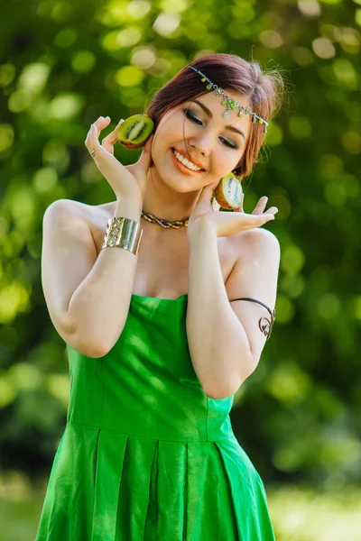 Mooie jonge Aziatische vrouw met kiwi — Stockfoto