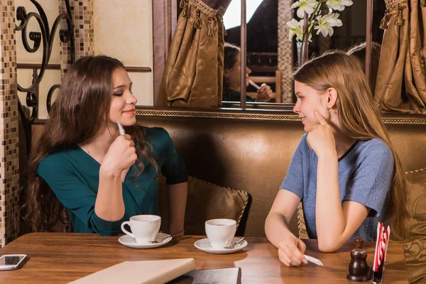 Two happy women plaing with sugar in cafe — Stock Photo, Image