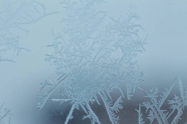 Frosty ice patterns on the window glass.