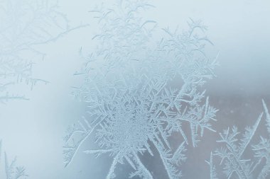 Frosty ice patterns on the window glass.