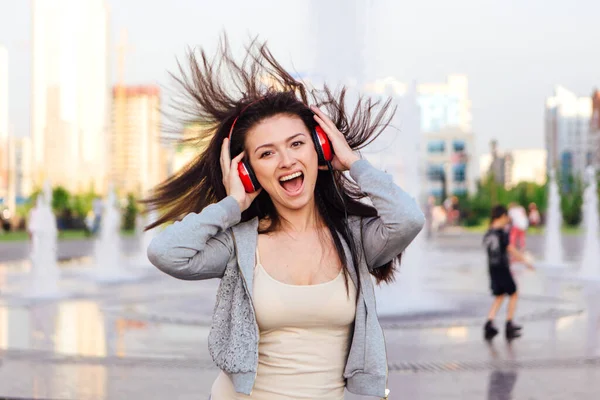 Girl listening to music streaming with headphones.