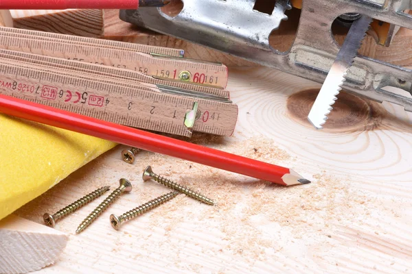 Close up of carpentry tools and electric jigsaw — Stock Photo, Image