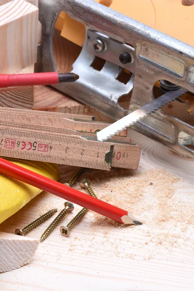 Close up of carpentry tools and electric jigsaw — Stock Photo, Image