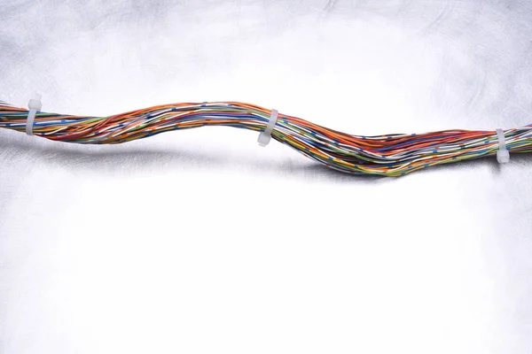 Metal arka plan üzerinde renkli elektrik kablolarının girdap — Stok fotoğraf
