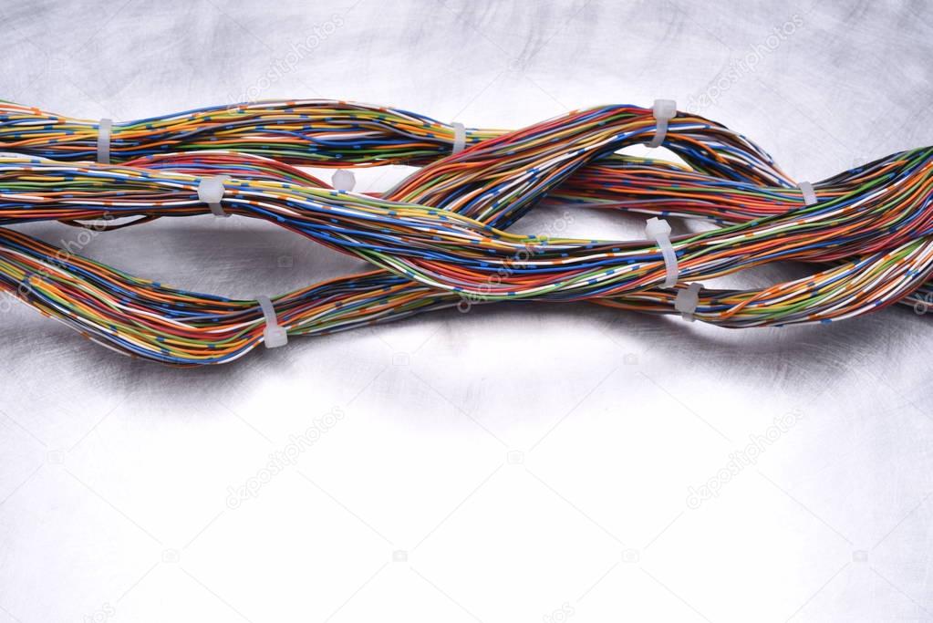 Swirl of Colorful Electrical Cables on Metal background 