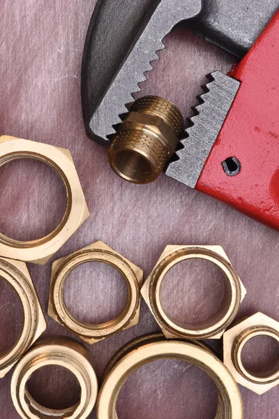 Wrench and brass fittings — Stock Photo, Image