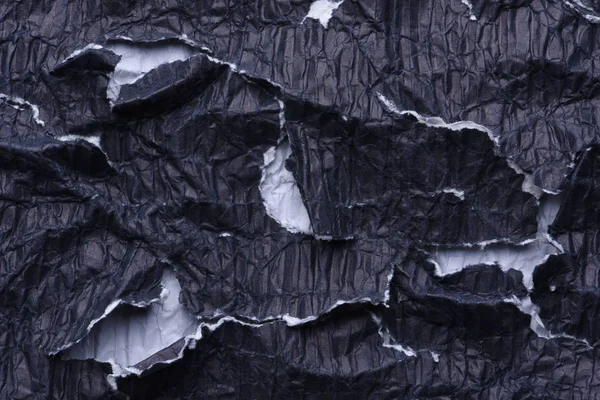 Морщинистая чёрная бумага — стоковое фото