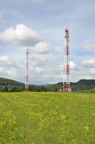İletişim kulesi bulutlu gökyüzü karşı bir tepe üzerinde