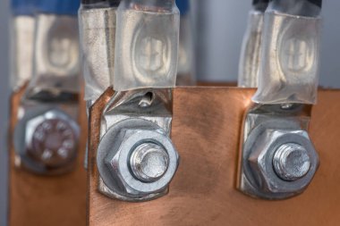 Elektrik santralindeki cıvatalar ve fındıklar sayesinde bakır otobüs çubuğuyla elektrik kablolarının birleşimi