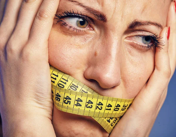 Woman with a taped tape on the lips. She is worried about the diet. — Stock Photo, Image