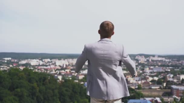 Attractive young man raises his hands to the sky — Stock Video