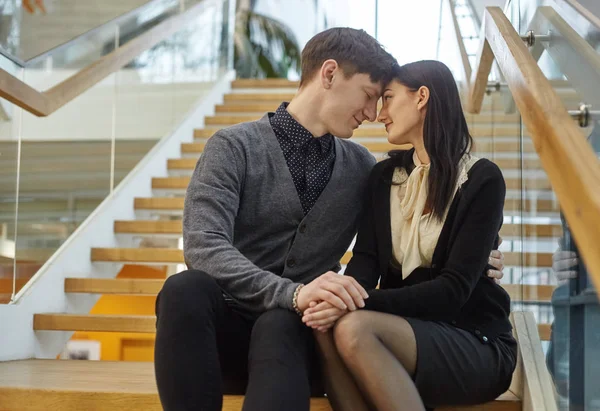 Lovely young loving couple sitting on stairs — 스톡 사진