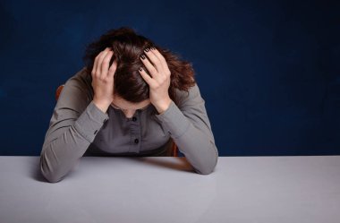 woman holding hands behind head. she is depressed.