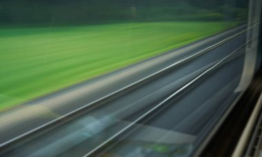a blurred texture of the railway through the train window