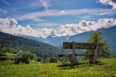 a bench on a mountain in the village of Castiel in Switzerland