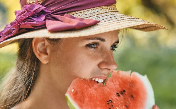 Όμορφη γυναίκα τρώει καρπούζι το καλοκαίρι στο πάρκο — Φωτογραφία Αρχείου