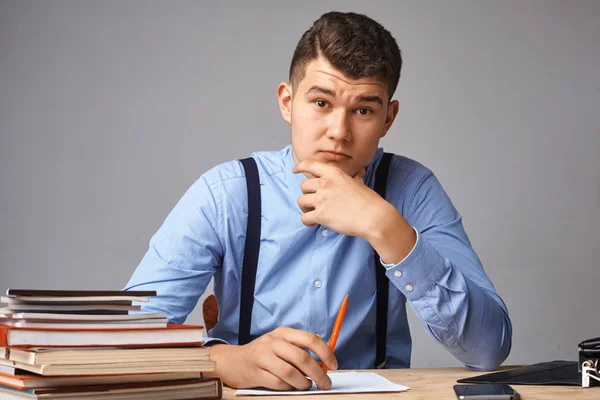 Young man in the workplace thinking about something — Stock Photo, Image