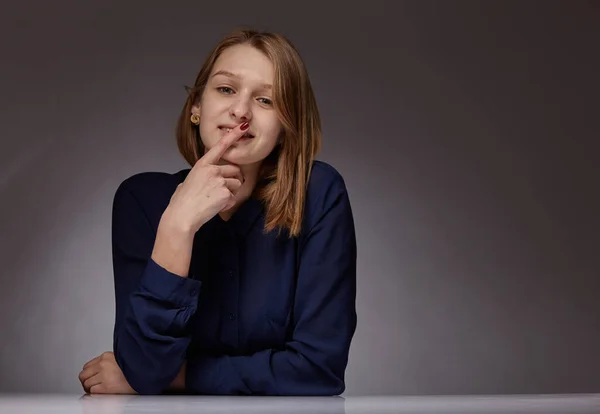 Jong mooi meisje in donkerblauw. glimlacht ze — Stockfoto