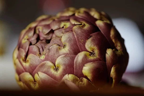 Purple artichoke head slowly rotating on a turn table.