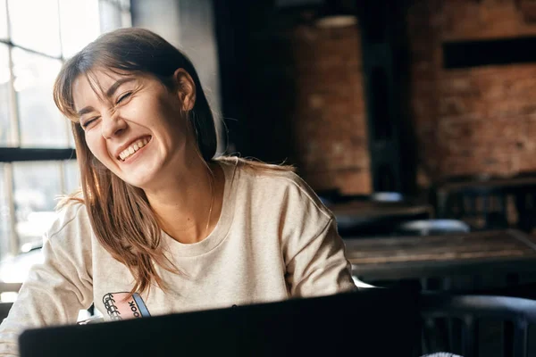 Mujer joven feliz se comunica en línea utilizando la computadora —  Fotos de Stock