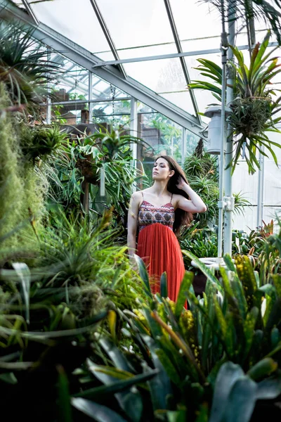 Beautiful woman in a greenhouse Stock Photo