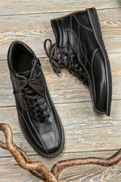 Different kinds of shoes on a wooden desk