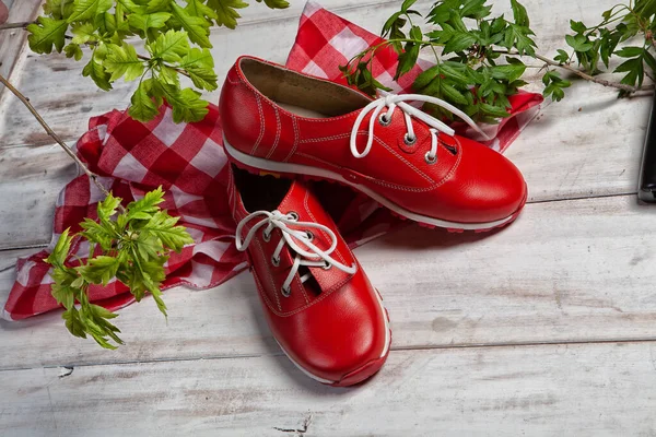 Different shoes  on an old wooden desk