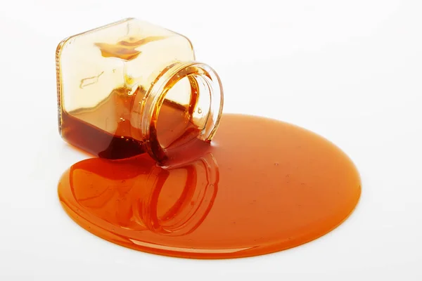 Μέλι πετρελαιοκηλίδα από ένα γυάλινο βάζο Royalty Free Εικόνες Αρχείου