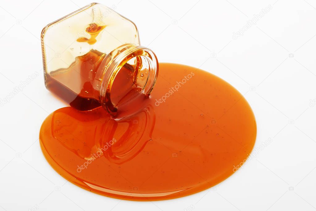 Honey spill from a glass jar