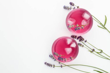 Lavender lemonade with lavender branches and ice on white background