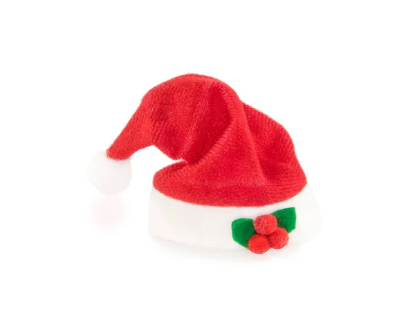 Červený Santa klobouk s ozdobou na bílém. — Stock fotografie