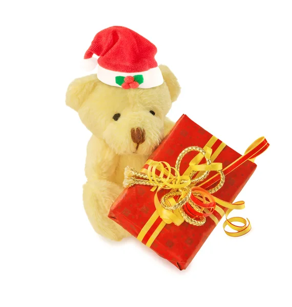 Urso de pelúcia com chapéu de Papai Noel e presente no branco . — Fotografia de Stock