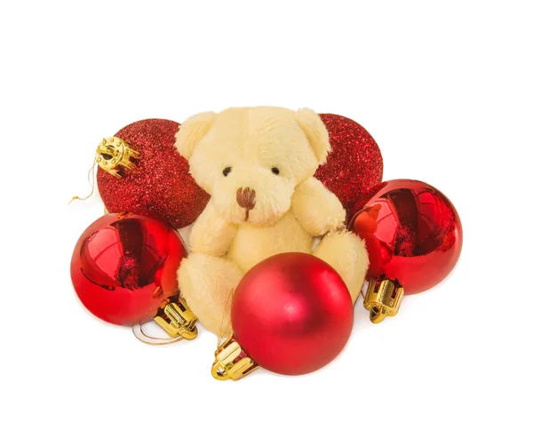 Teddy bear with five red Christmas balls on white. Stock Picture