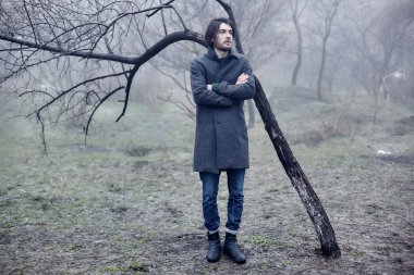 Denize yakın yürüyüş gri paltolu adam