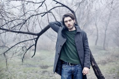 Denize yakın yürüyüş gri paltolu adam