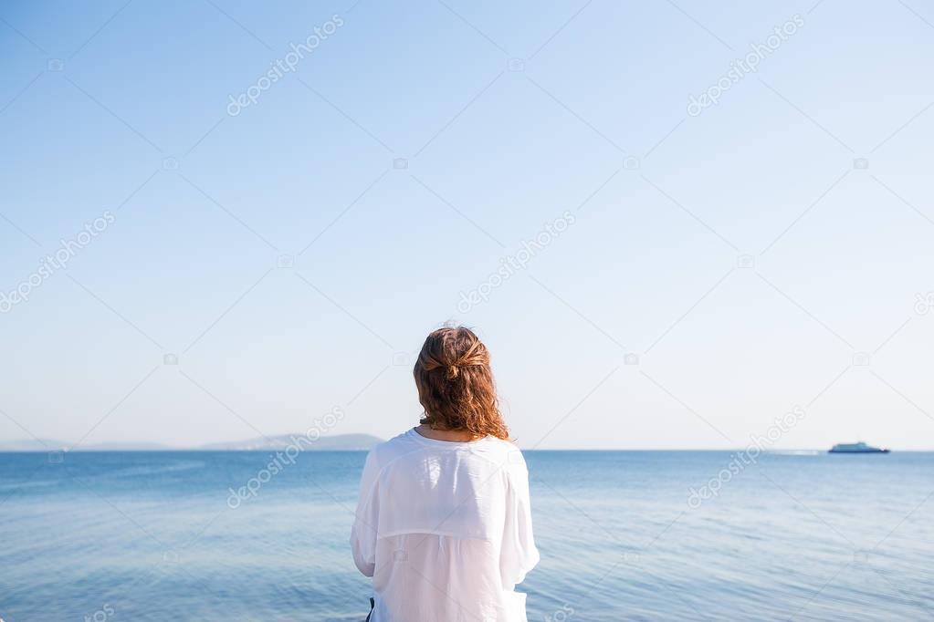 young woman standing at the seaside