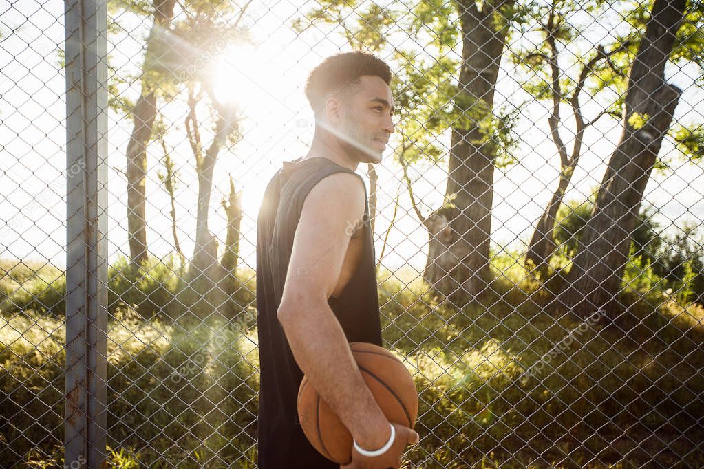 man with ball on basketball court